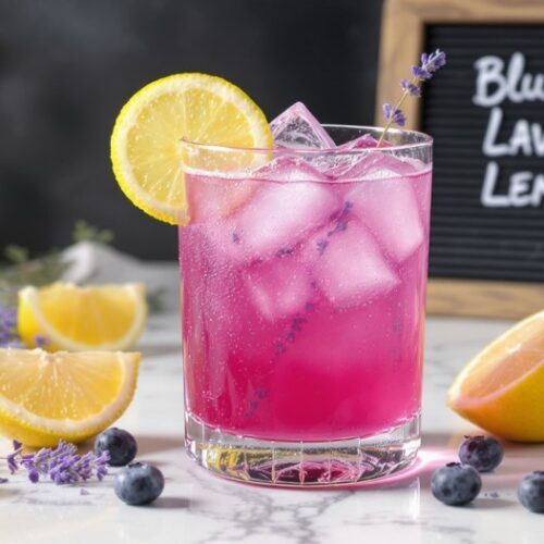 A detailed, photorealistic illustration of a vibrant, naturally pink blueberry lavender lemonade drink, featuring fresh lemons, wild blueberries, and delicate floral lavender notes. The drink is presented in a minimalist highball glass on a honed white marble surface, with key ingredients like lemon wedges and lavender sprigs arranged around the glass. with a black board and hand written Blueberry Lavender Lemonade Recipe